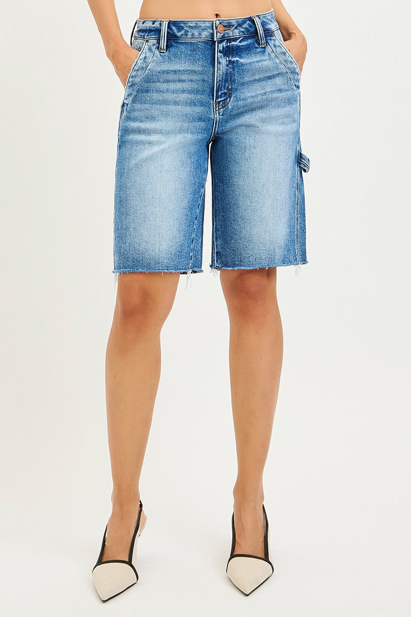 Person wearing light blue denim shorts on a white background