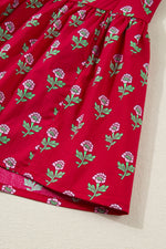 Red fabric with floral pattern on a beige surface