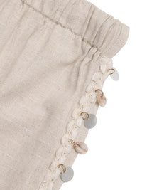 Beige fabric with decorative buttons on a white background