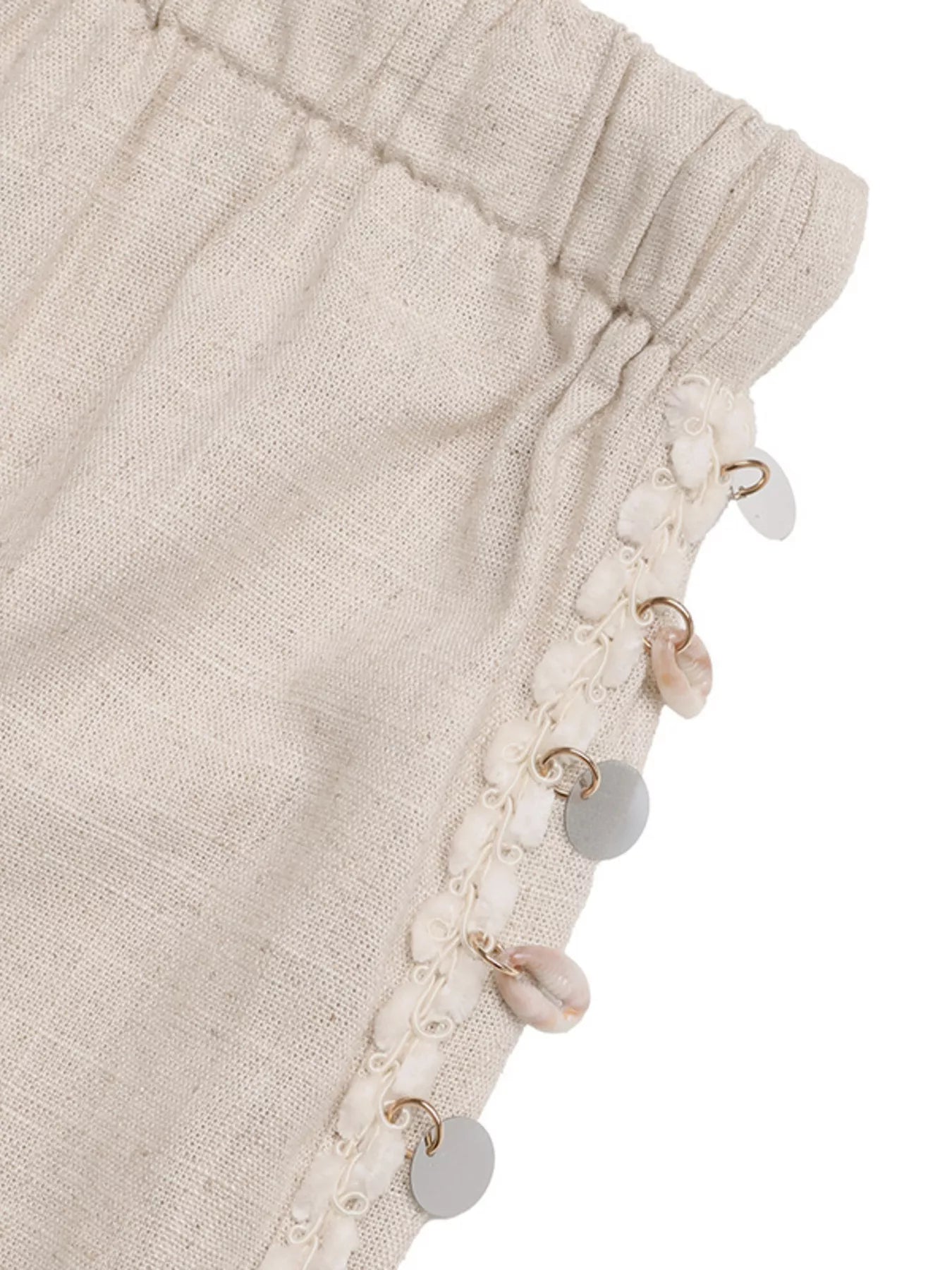 Beige fabric with decorative buttons on a white background