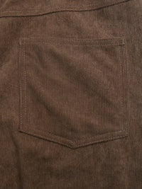 Close-up of brown corduroy fabric with a pocket