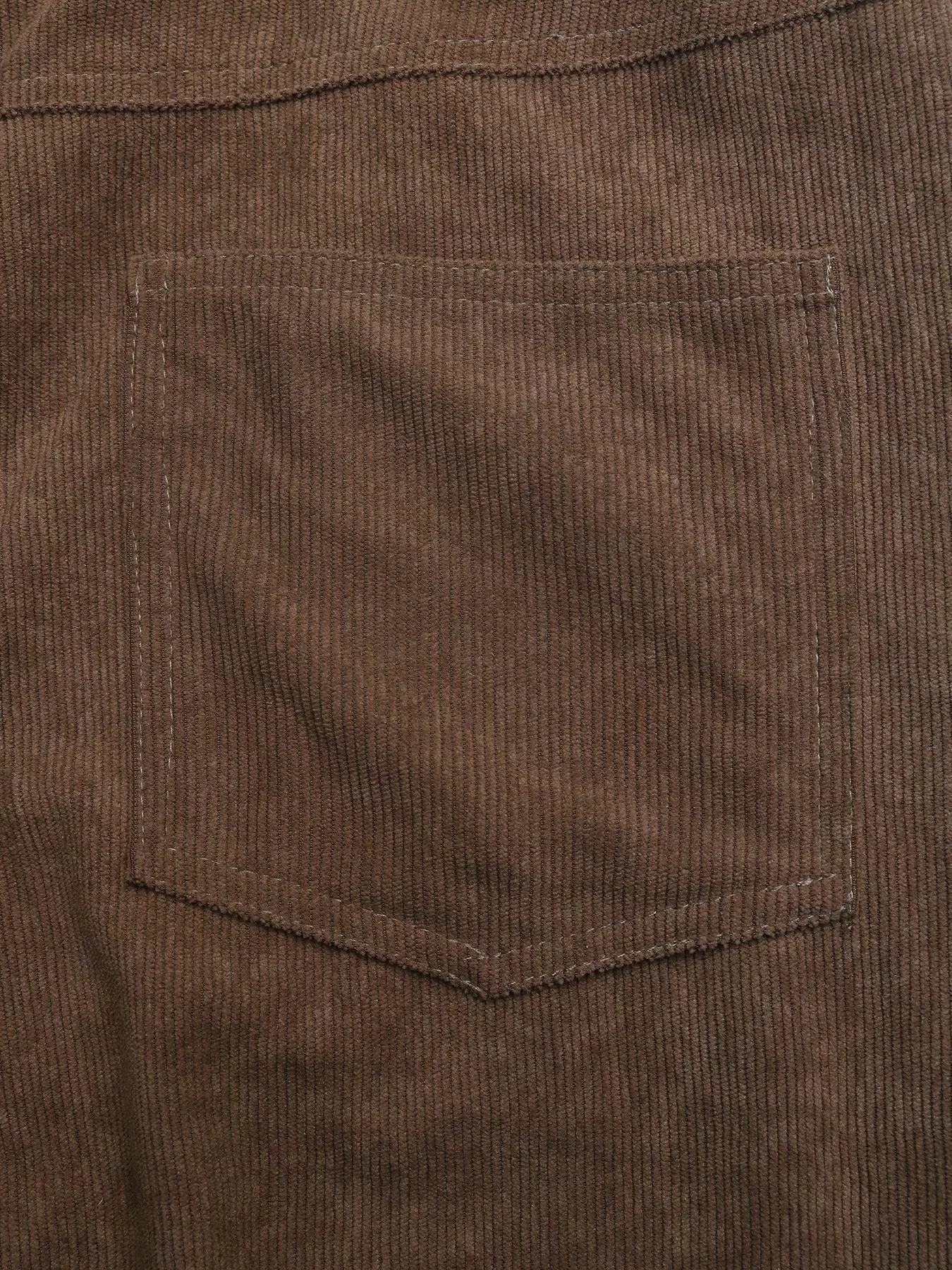 Close-up of brown corduroy fabric with a pocket