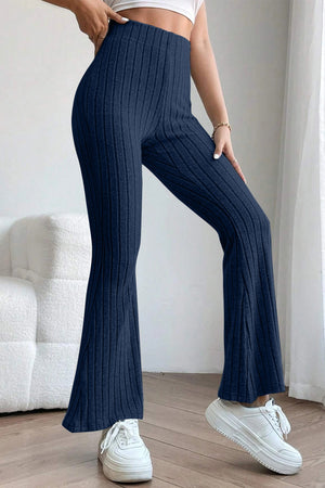 Model posing in blue Basic Bae Full Size Ribbed High Waist Flare Pants