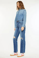Woman wearing a denim outfit with a white background