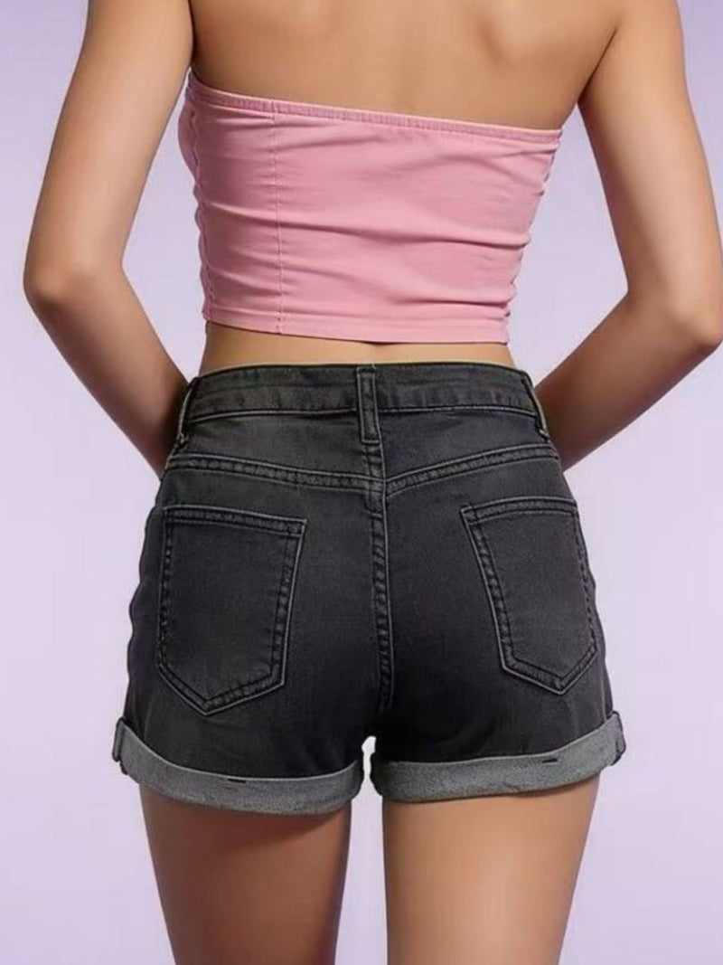 Person wearing a pink tube top and black shorts on a light purple background