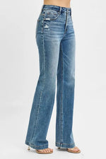 Blue jeans worn by a person on a white background