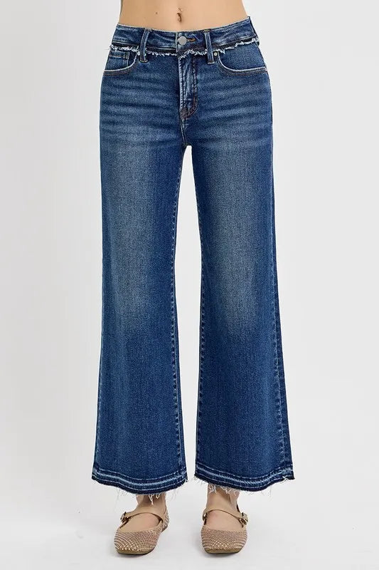 Blue jeans worn by a person on a white background