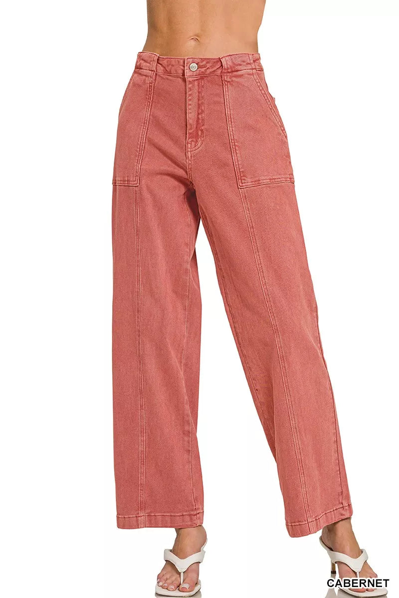 Pink jeans worn by a person on a white background