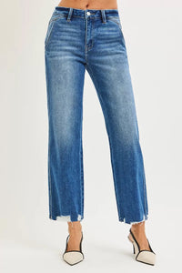 Blue jeans worn by a person on a white background