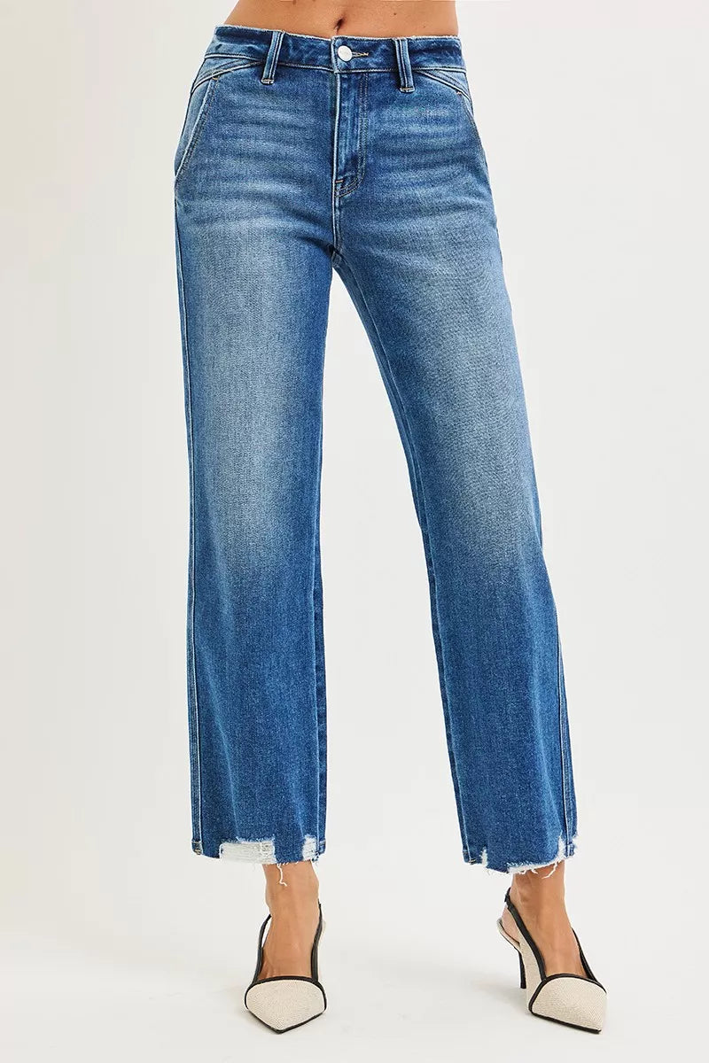 Blue jeans worn by a person on a white background