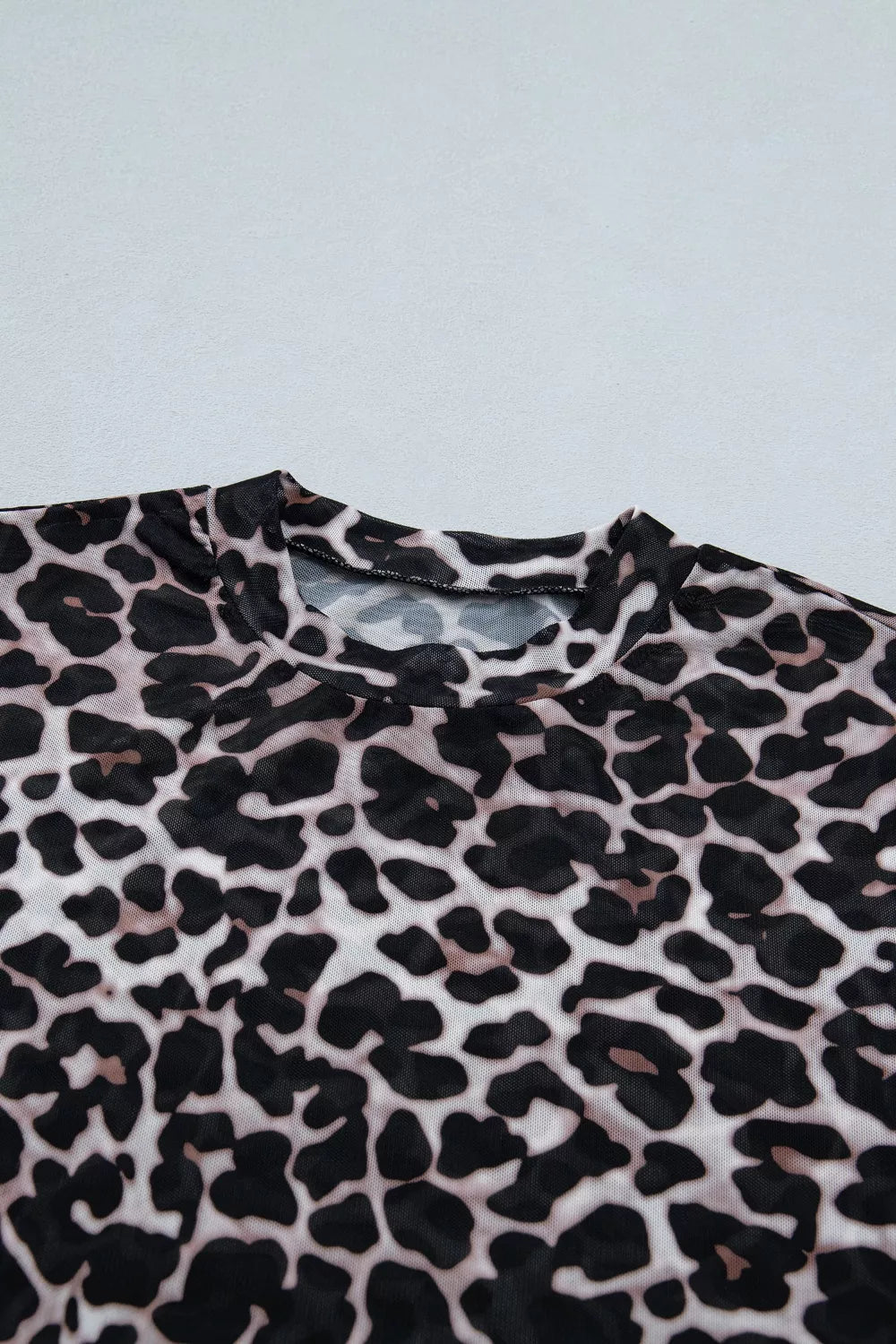 Leopard print fabric on a light blue background