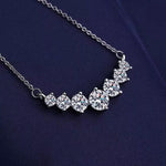 Silver necklace with round crystals on a dark blue fabric background
