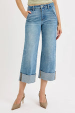 Wide-leg jeans worn by a person on a white background