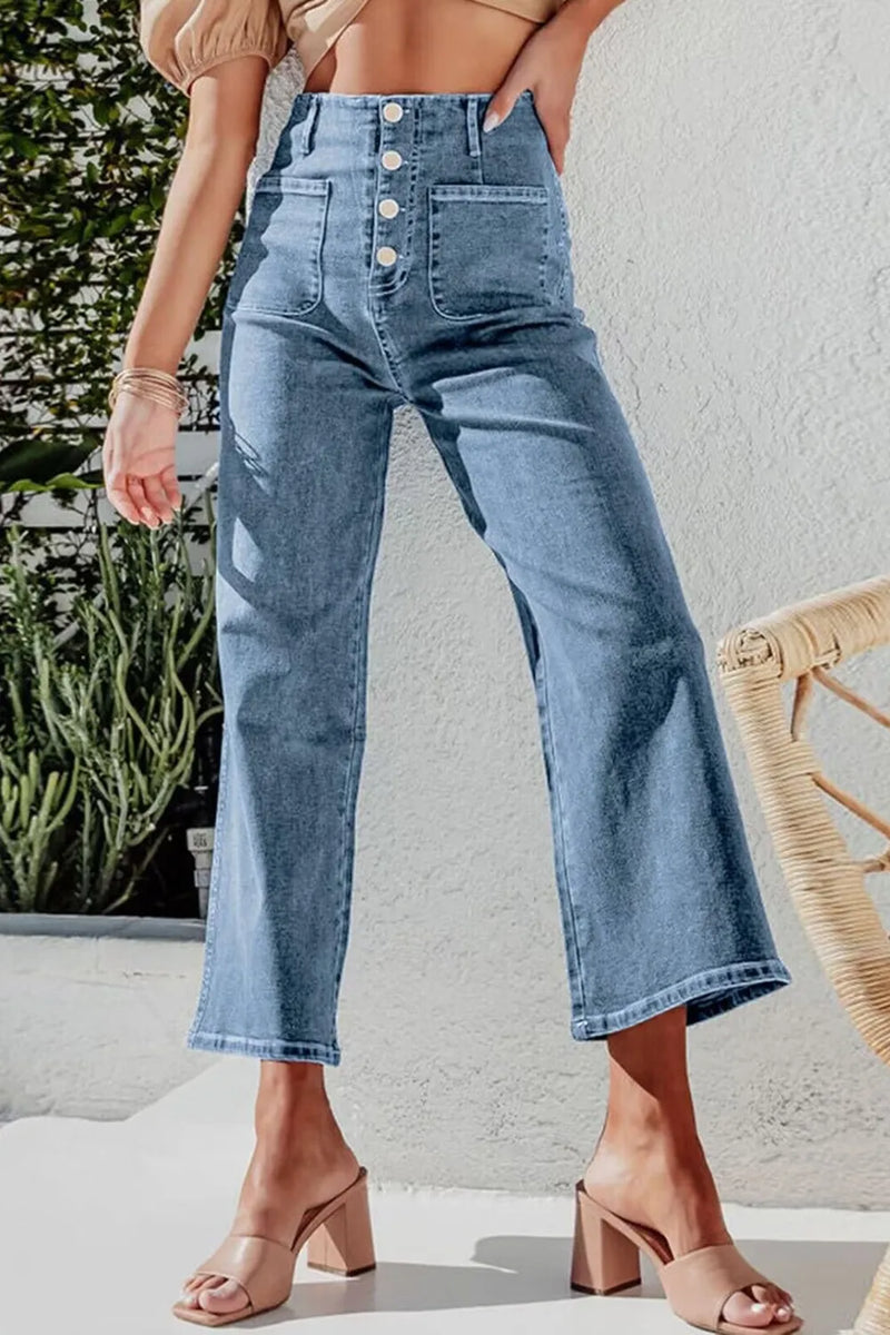 Person wearing blue jeans with a blurred background