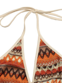 Triangular bikini top with patterned design on a white background