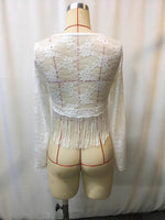 White lace top on a mannequin against a plain background