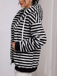 Black and white striped hoodie worn by a person on a plain background