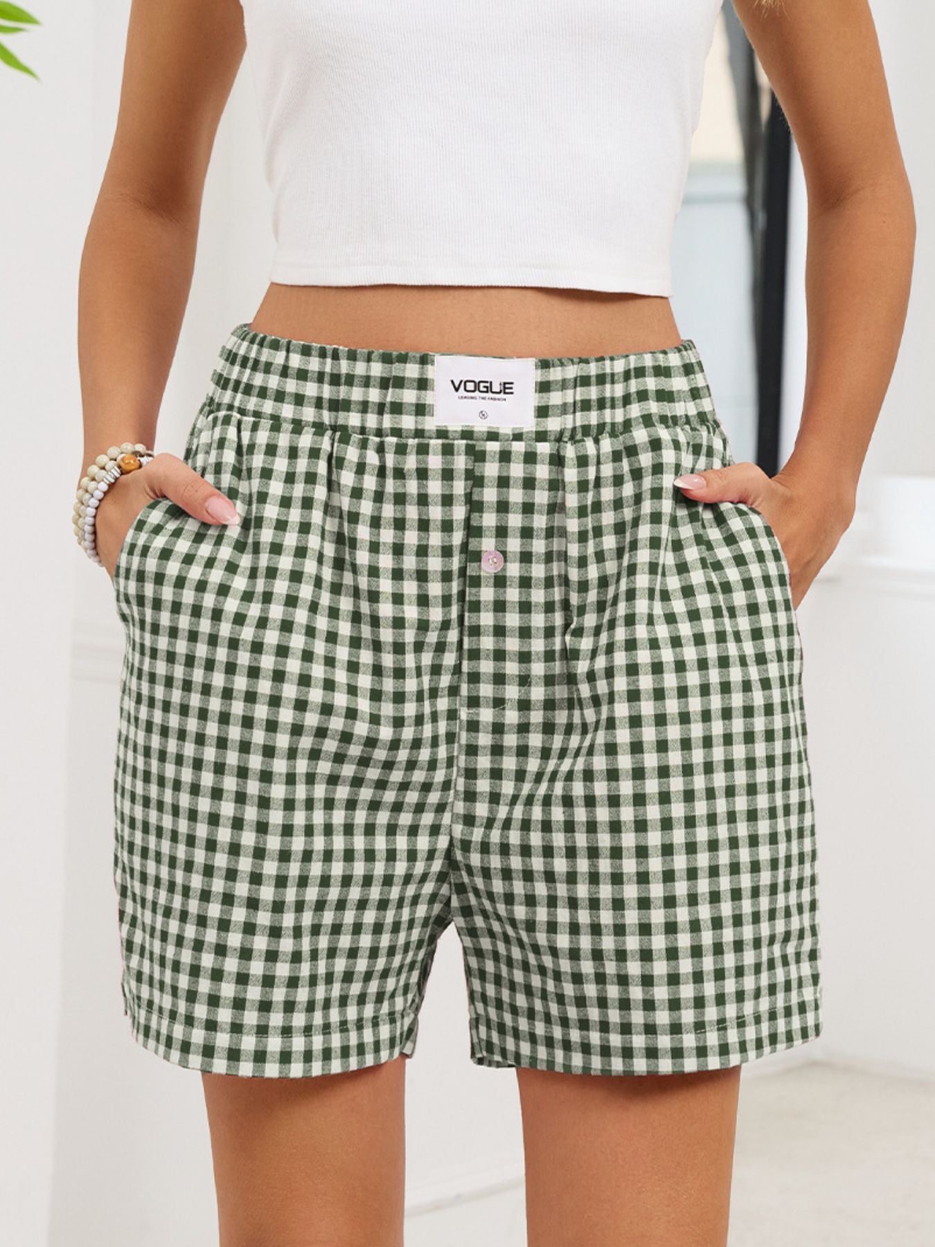 Green and white checkered shorts with a visible brand logo on a plain background
