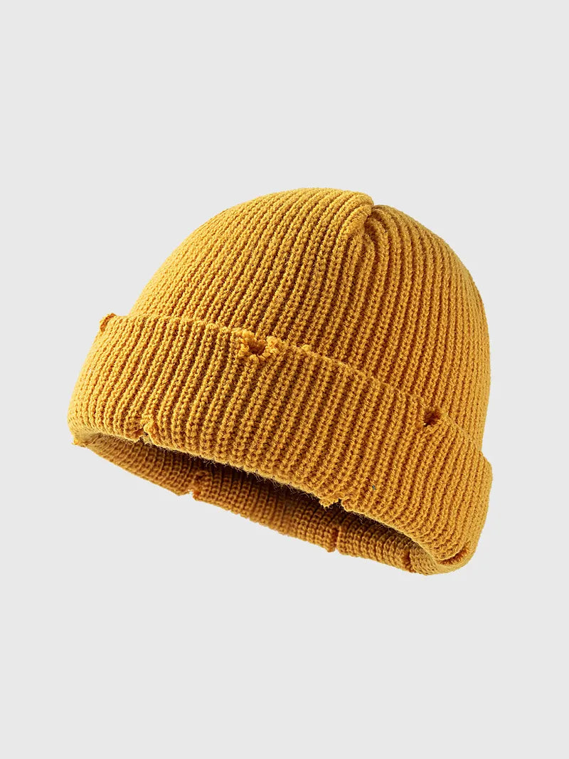 Yellow knit beanie on a light gray background
