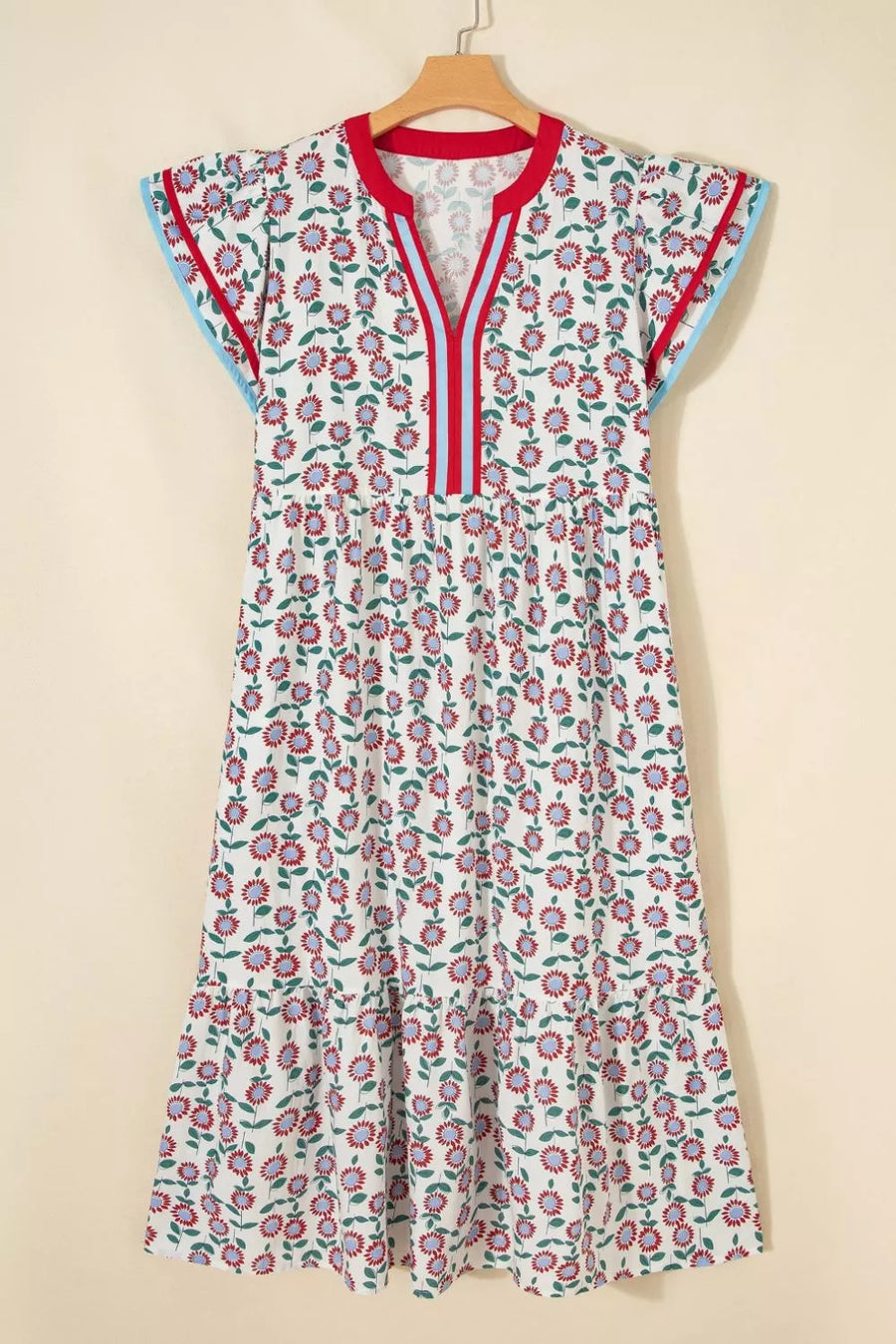Floral dress with red accents on a beige background
