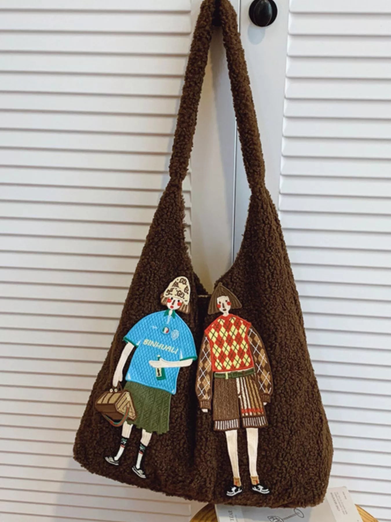 Brown bag with illustrations of people on a white background
