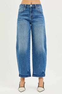 Blue jeans worn by a person on a white background
