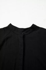Close-up of a black garment with a collar on a white background