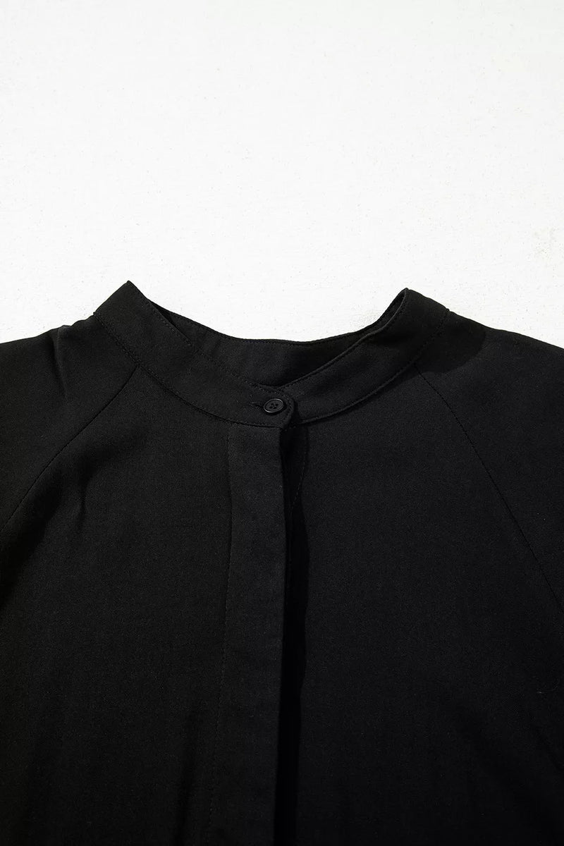 Close-up of a black garment with a collar on a white background