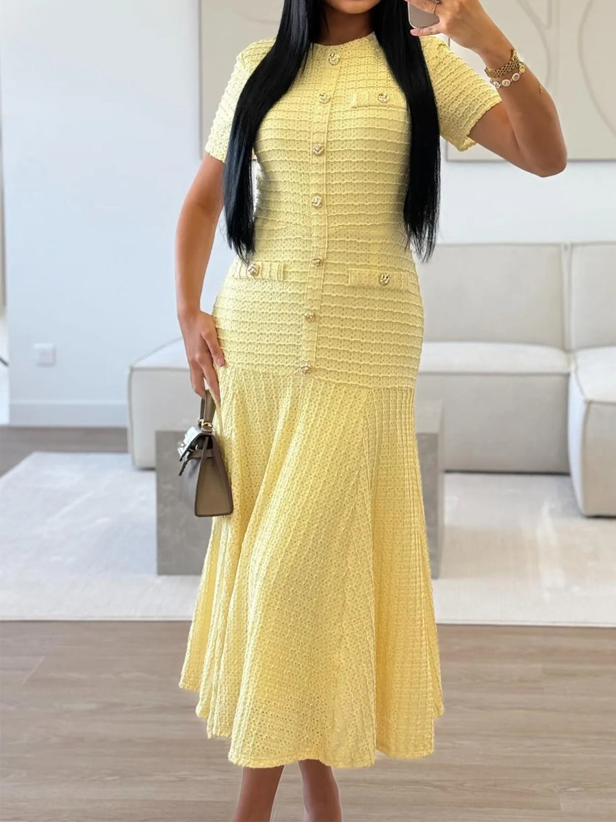 Woman wearing a yellow dress in a modern living room.