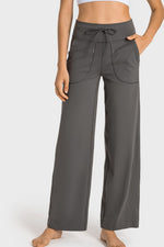 Person wearing gray wide-leg pants on a white background
