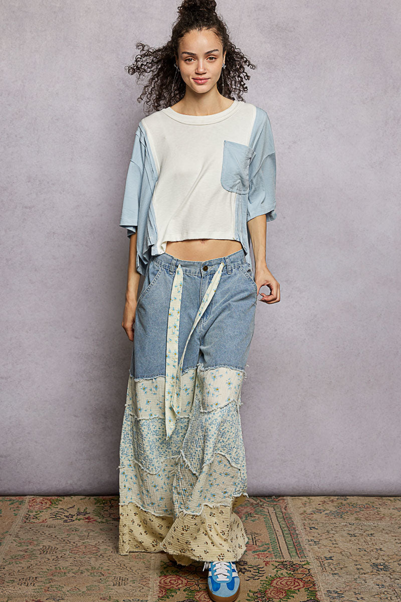 Woman wearing a patchwork outfit with a plain background
