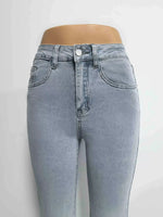 Light blue jeans on a mannequin against a white background