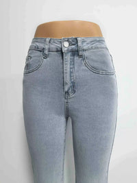 Light blue jeans on a mannequin against a white background