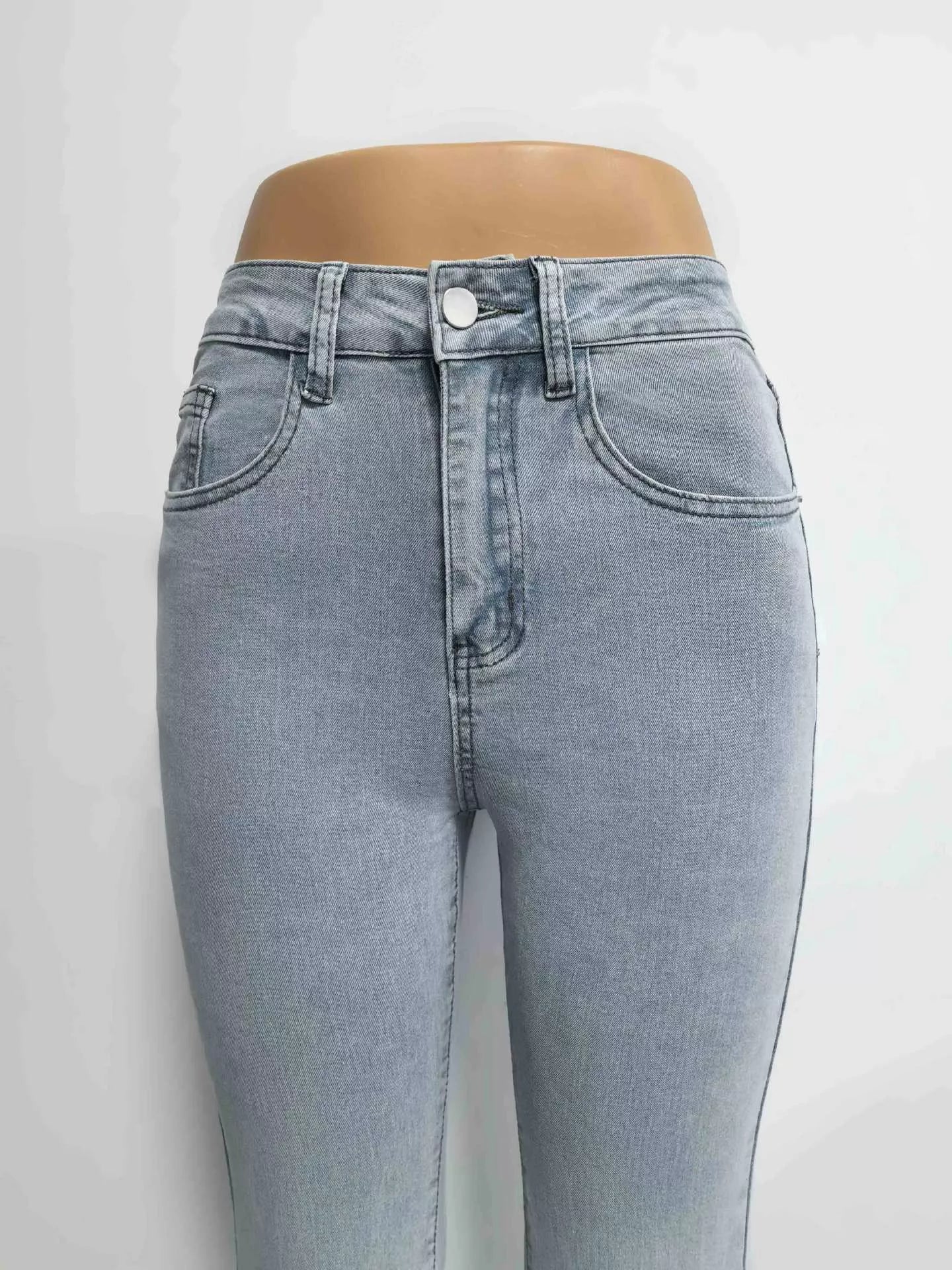 Light blue jeans on a mannequin against a white background