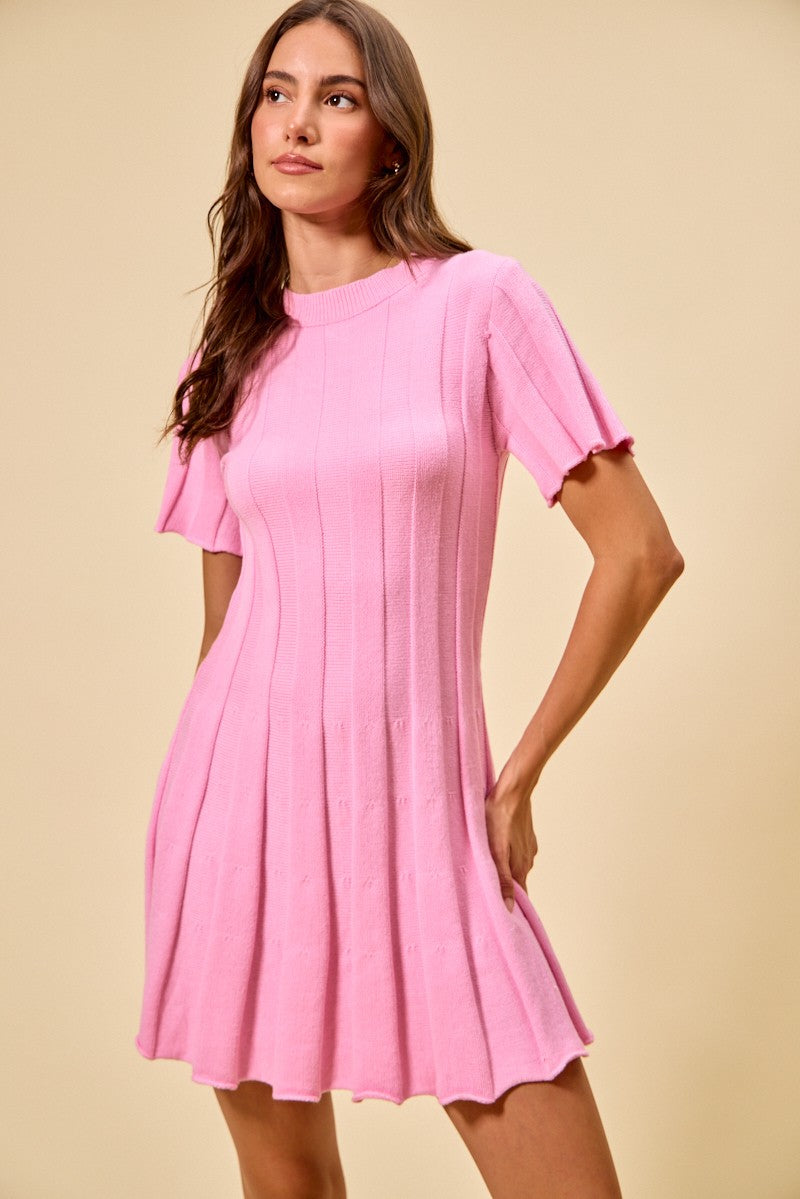 Woman wearing a pink dress against a beige background