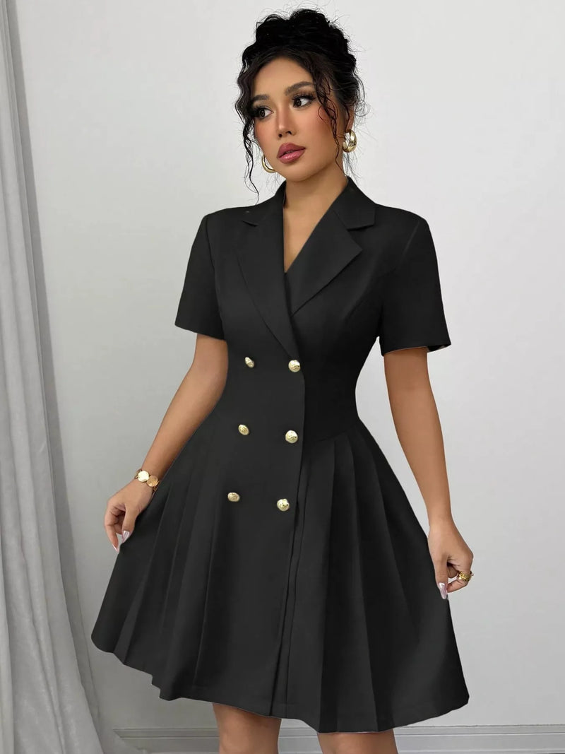 Woman wearing a black dress with gold buttons against a gray background