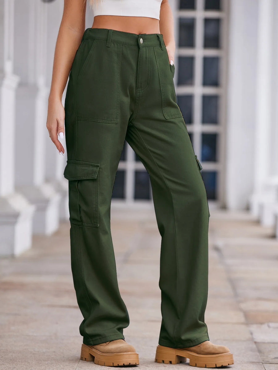 Person wearing green cargo pants standing on a wooden deck.