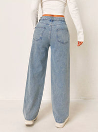 Light blue jeans worn by a person on a white background