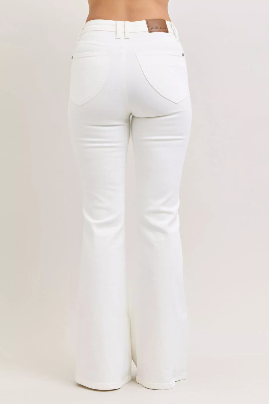 White jeans on a plain background