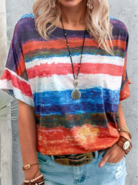 Person wearing a colorful striped shirt with a gray background