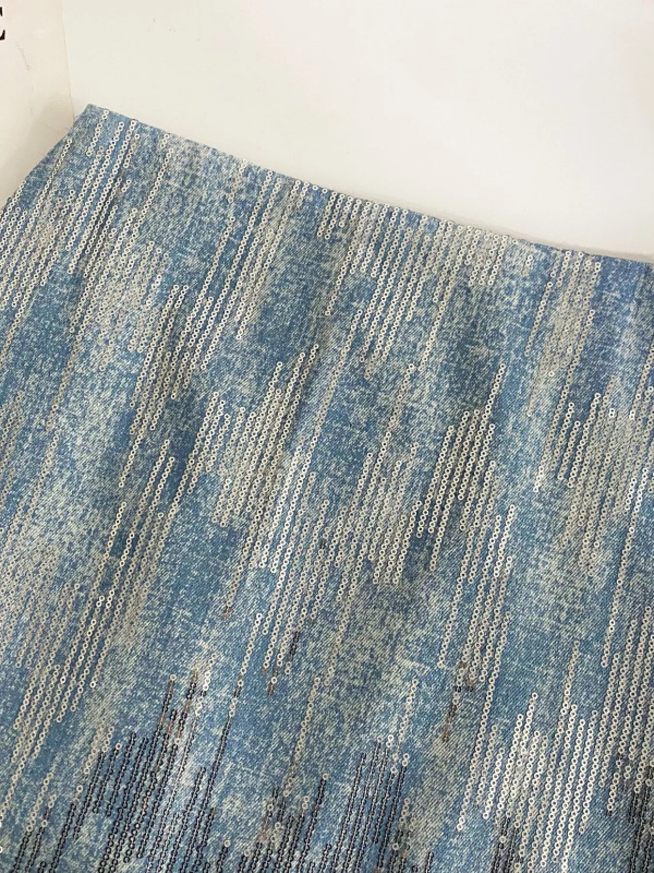 Close-up of a textured blue and gray rug on a white background