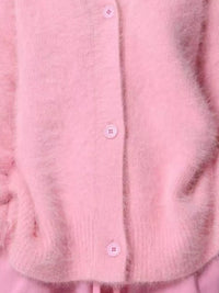 Close-up of a pink textured fabric with buttons
