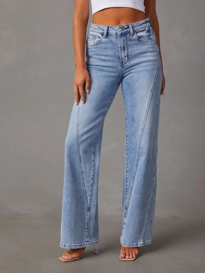 Light blue jeans worn by a person on a gray background