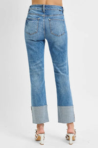 Blue jeans with cuffed hem on a white background
