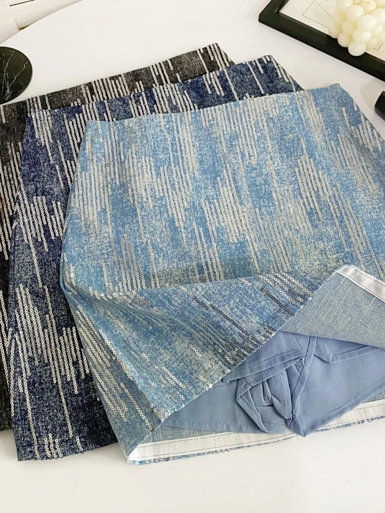 Two blue patterned rugs on a white surface