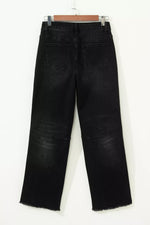 Black jeans on a hanger against a white background