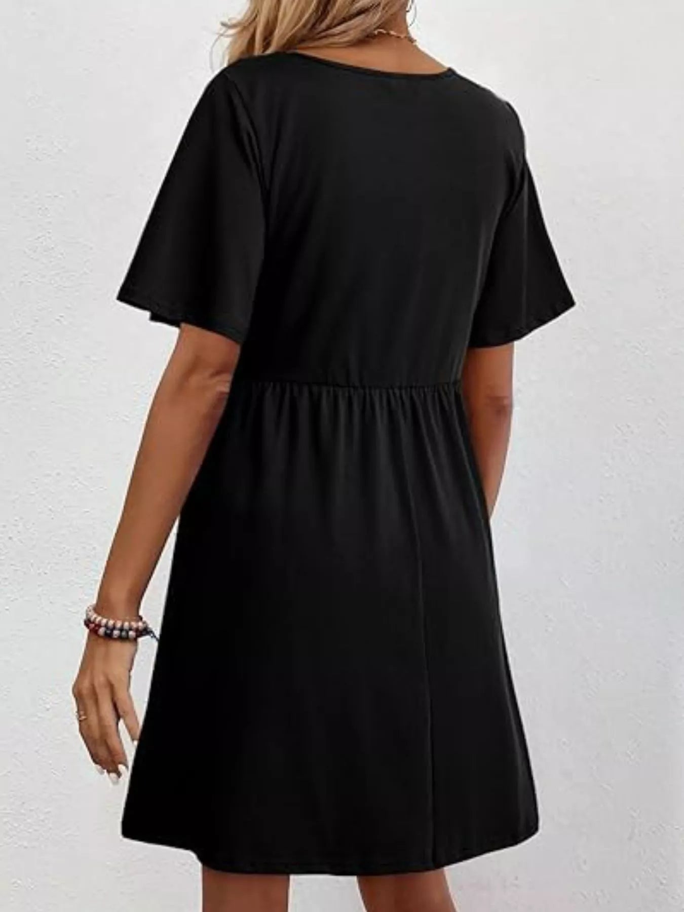 Black dress worn by a person on a white background