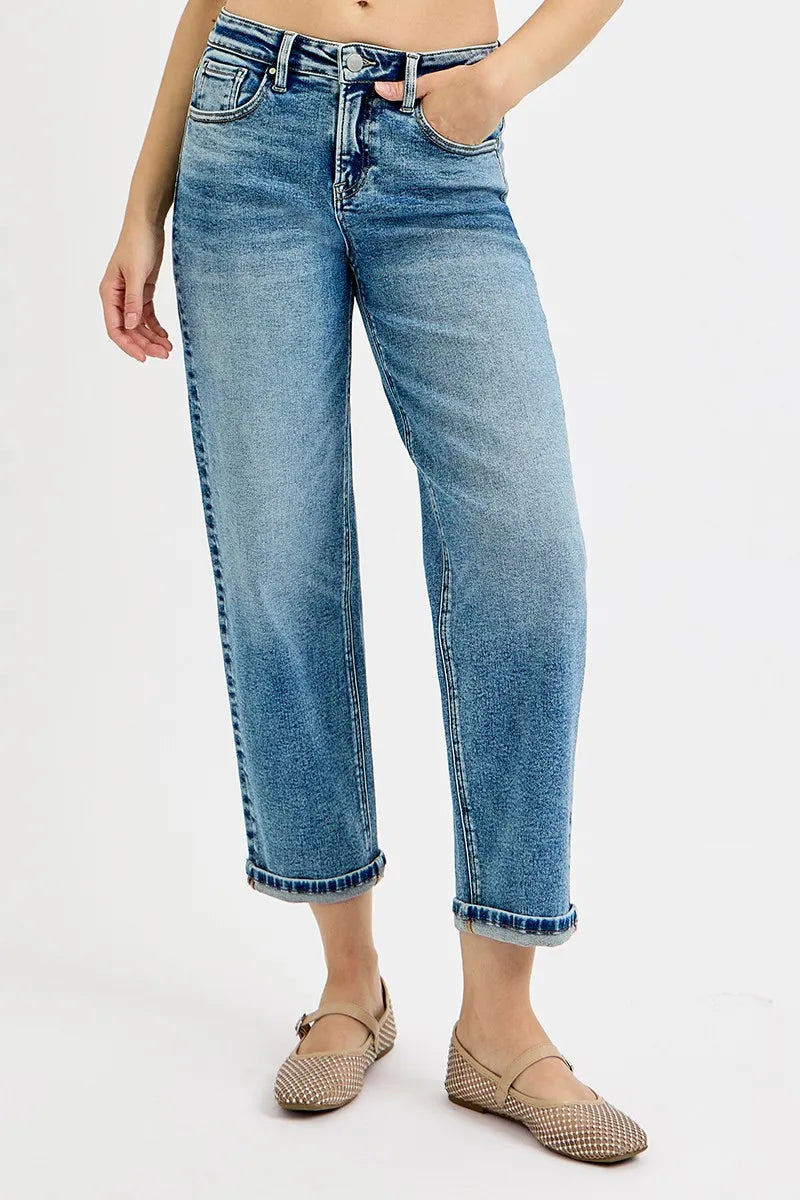 Person wearing light blue jeans on a white background