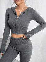 Person wearing a gray zip-up hoodie and matching leggings against a white background