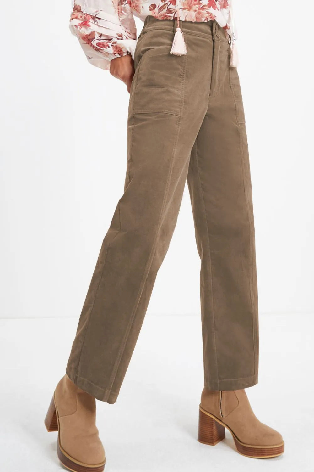 Brown pants worn by a person on a white background